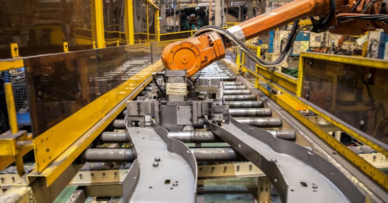 Robot arms handle tool keep automotive part to spot machine in car factory.