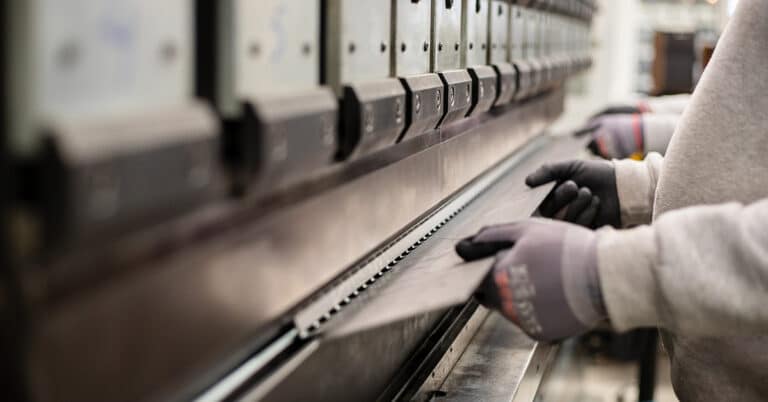 The technician operator working with press brake hydraulic bending machine.